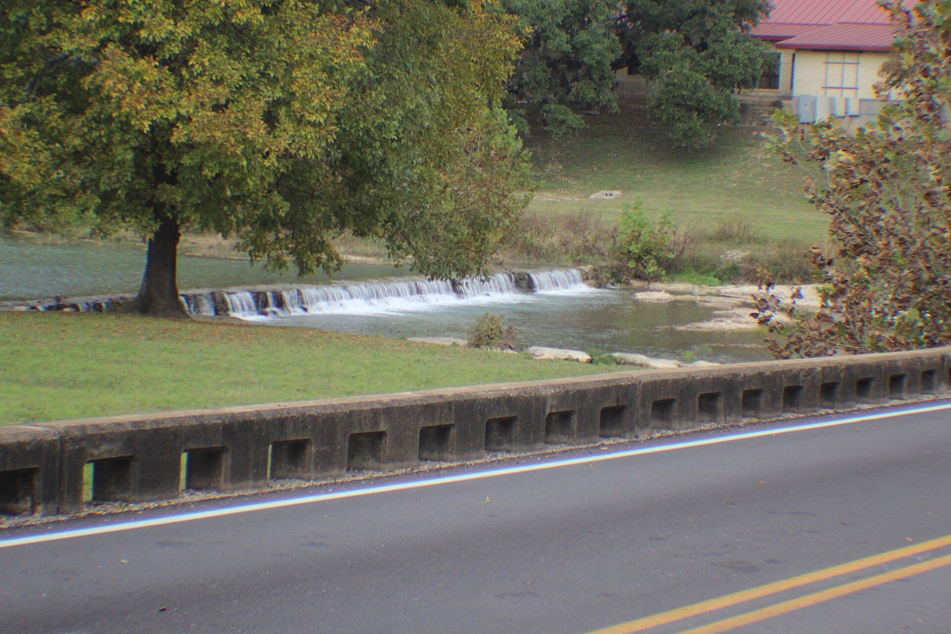 Salado Creek's low-water crossing and tree canopy near Main Street in Salado, Texas